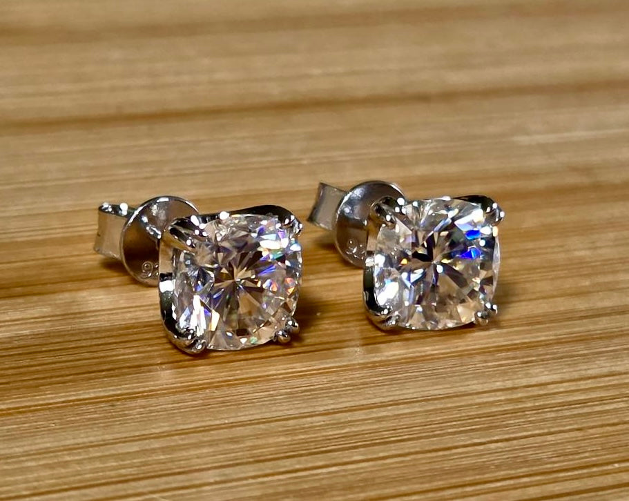 6ctw cushion-cut Moissanite studs in elegant sterling silver double-claw mountings! With brilliant faceting, these earrings are showstoppers!