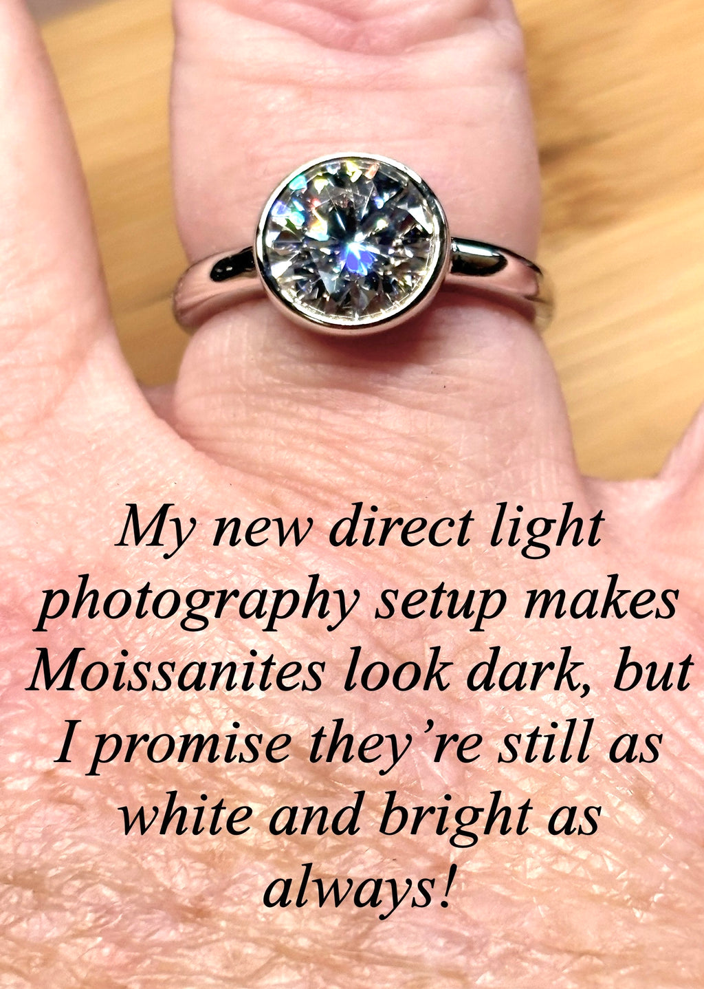 Moissanite solitaire. A 3ct certified round brilliant Moissanite in a weighty solid sterling silver bezel mounting with Seiko-electroplated 18k! A sleek, minimalist design!
