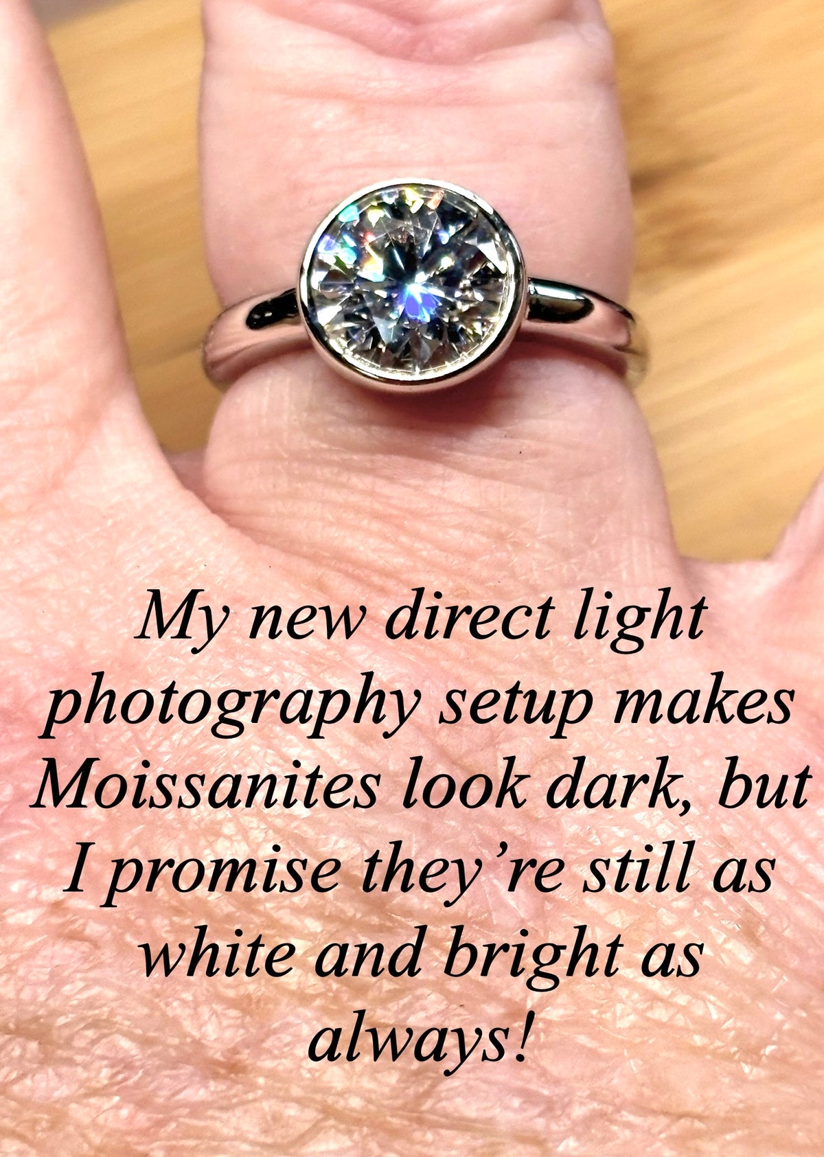 Moissanite solitaire. A 3ct certified round brilliant Moissanite in a weighty solid sterling silver bezel mounting with Seiko-electroplated 18k! A sleek, minimalist design!
