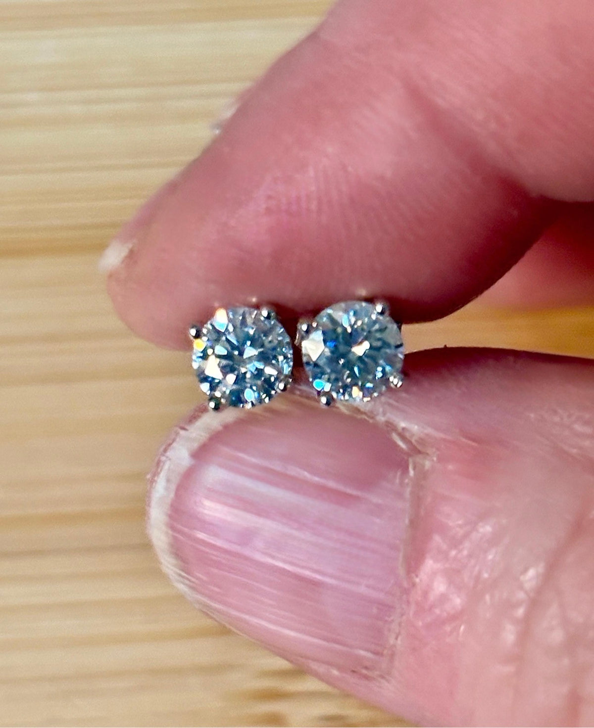 1cttw DOUBLE certified Moissanite studs with D-color and VVS1 clarity! Set in sterling silver bathed in 18k white gold, they’re a cut above!