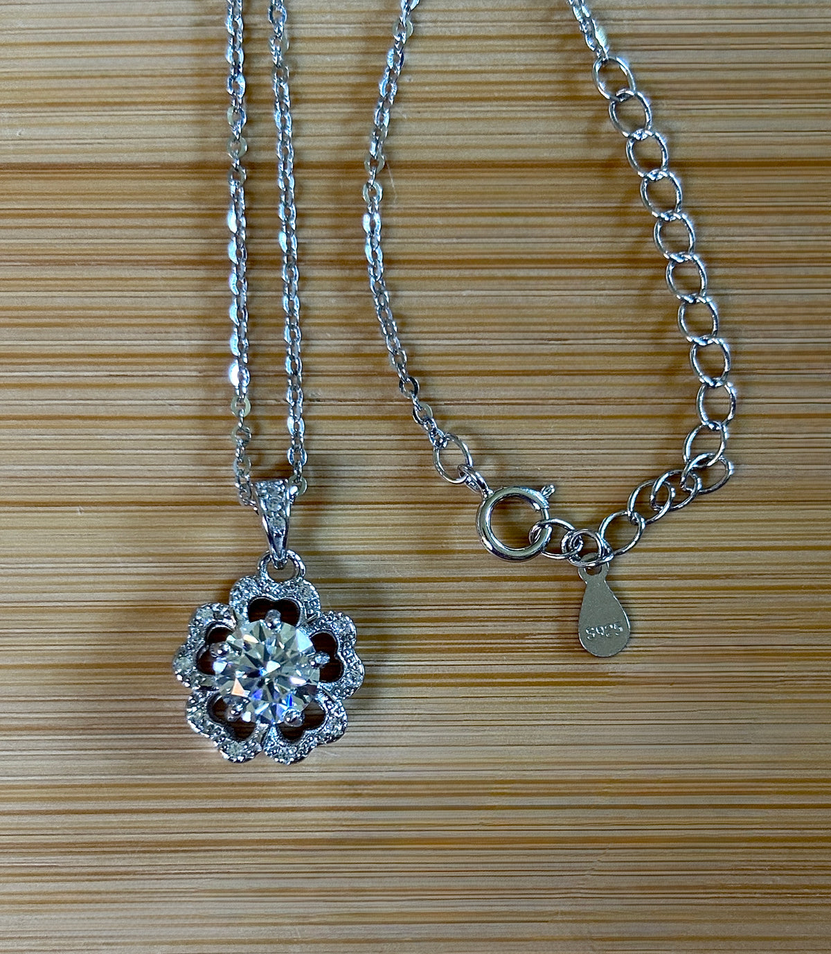 Moissanite necklace. A certified 1ct Moissanite hibiscus necklace with white zircon accents in solid sterling and white rhodium!