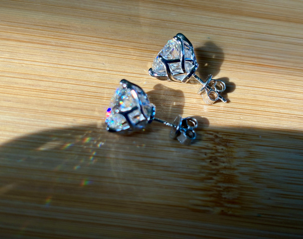 A 10ctw pair of double certified Moissanite studs in lotus-shaped sterling silver baskets!