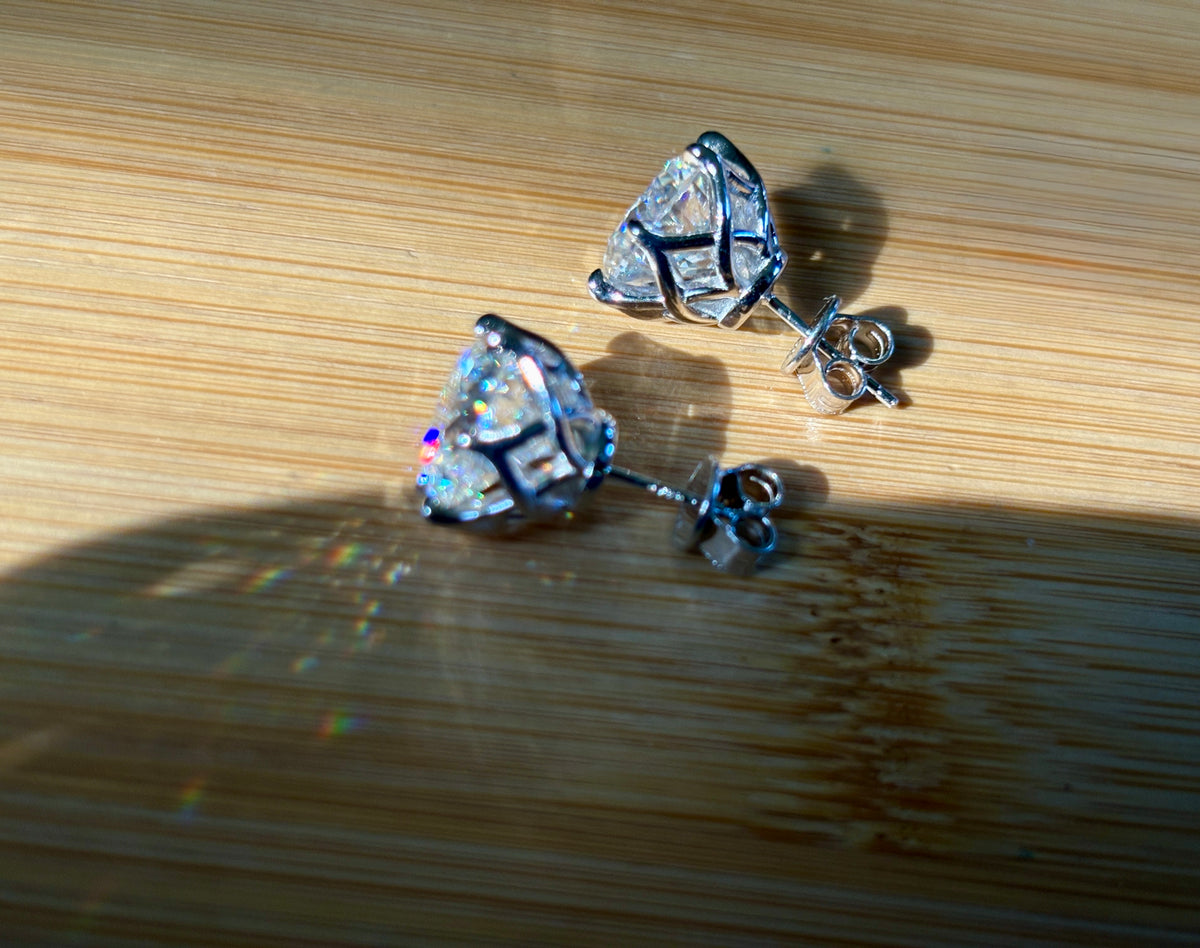 A 10ctw pair of double certified Moissanite studs in lotus-shaped sterling silver baskets!
