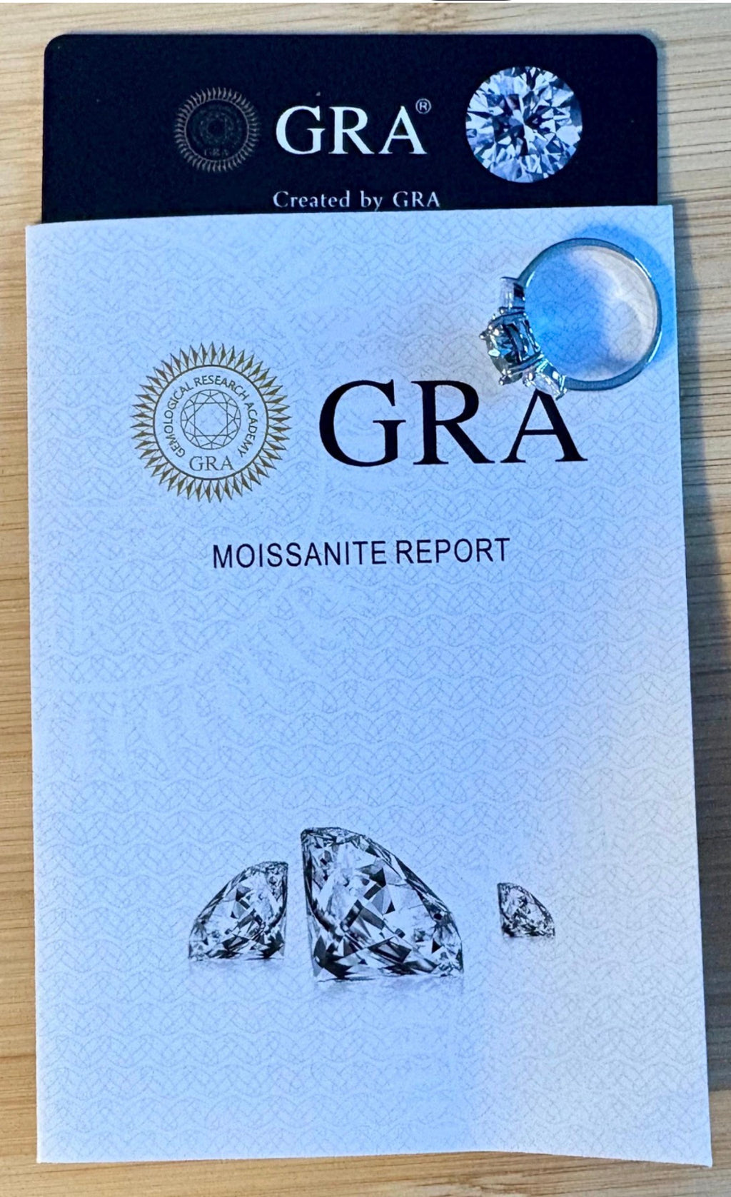 Moissanite ring. A 3ct certified GRAY Moissanite with 1.5cttw of heart-cut white zircons, set in a sterling silver basket 3-stone design!
