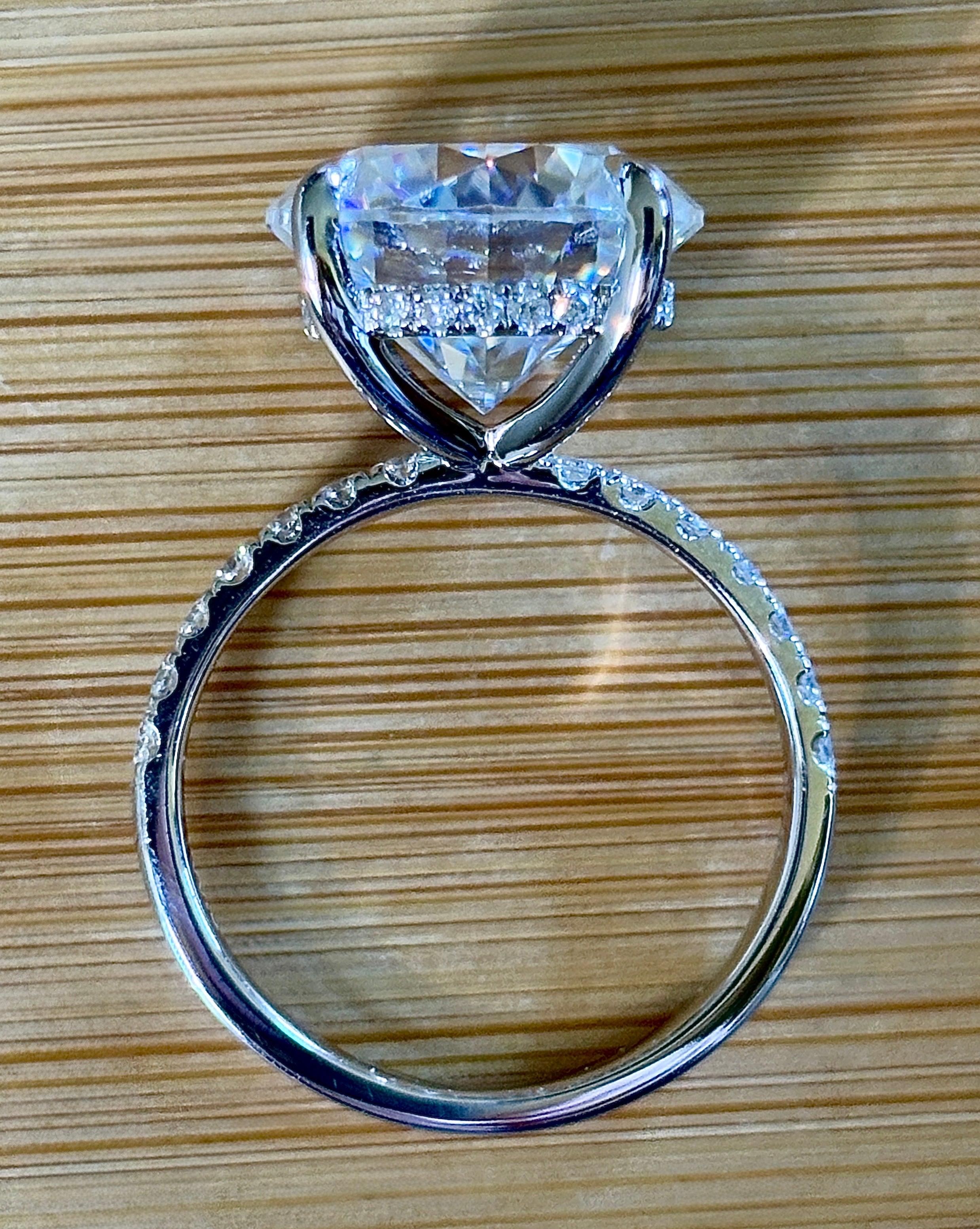 Moissanite solitaire. A glorious 10ct 8H8A Moissanite in a 4-prong mounting with a Moissanite “hidden halo” and shoulders, an 11.3cttw ring!