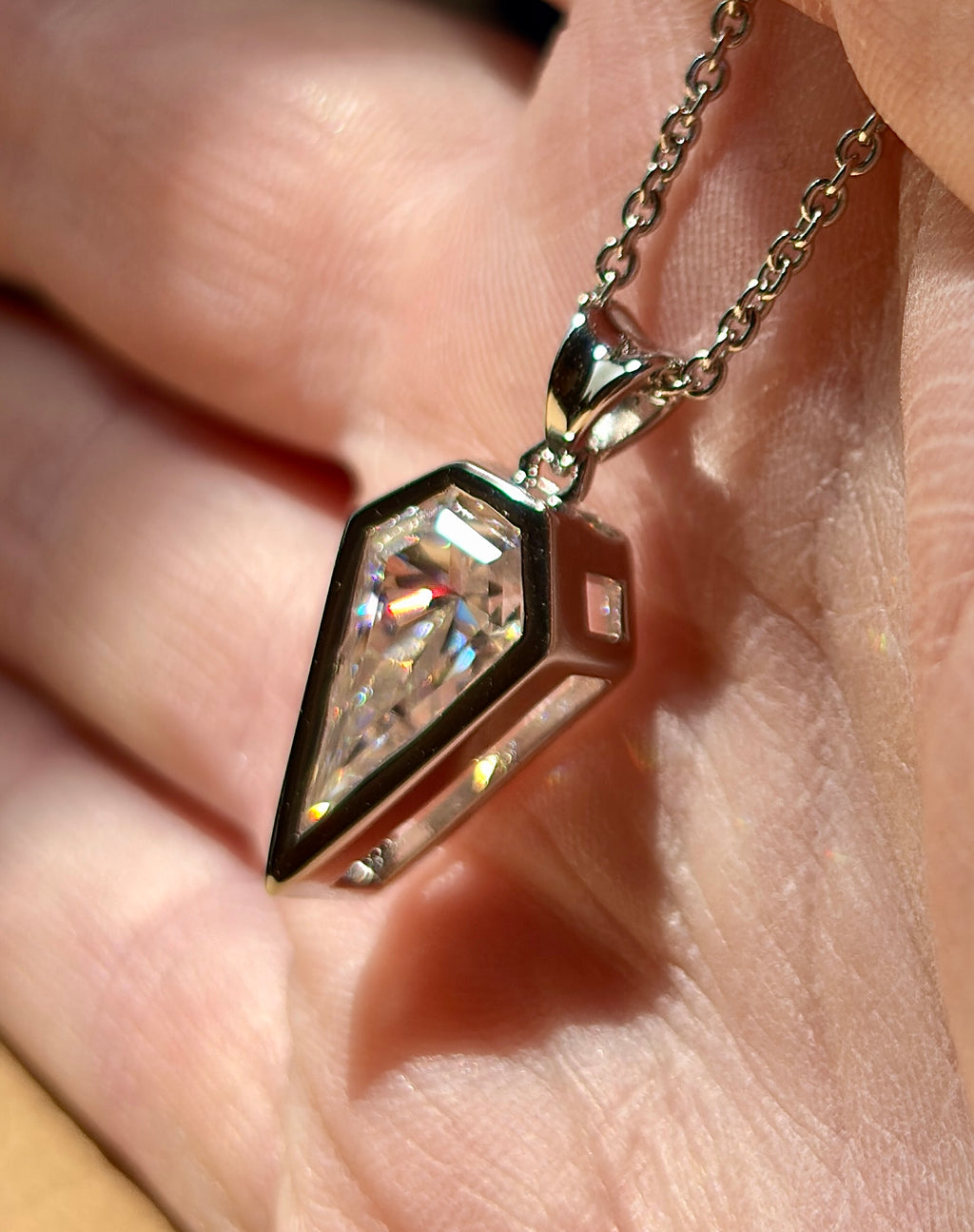 Moissanite necklace. “Flight!”, a kite-shaped, custom-cut 5ct Moissanite pendant! Hand-faceted by a master stone cutter and set in Argentium silver, it is suspended on a 20” sterling silver chain and is exclusive to Hand Knotted Jewelry!