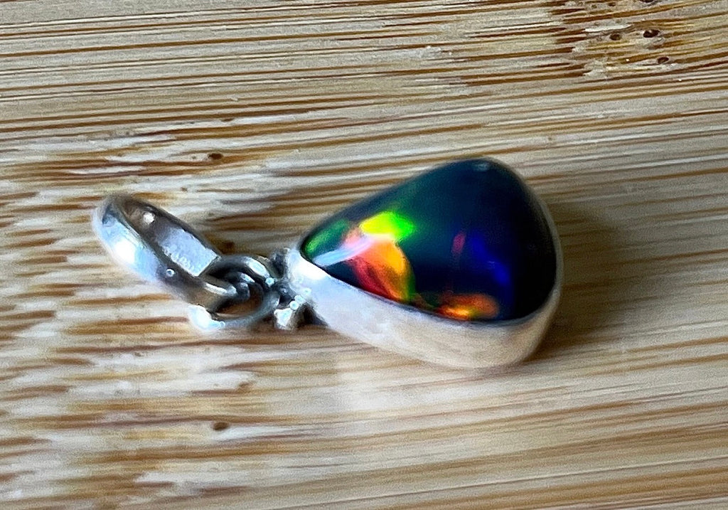 2.99ct Ethiopian opal pendant. AAA grade smoked opal cabochon pear in solid sterling silver. This flashy stone measures 9.6mm x 13mm!