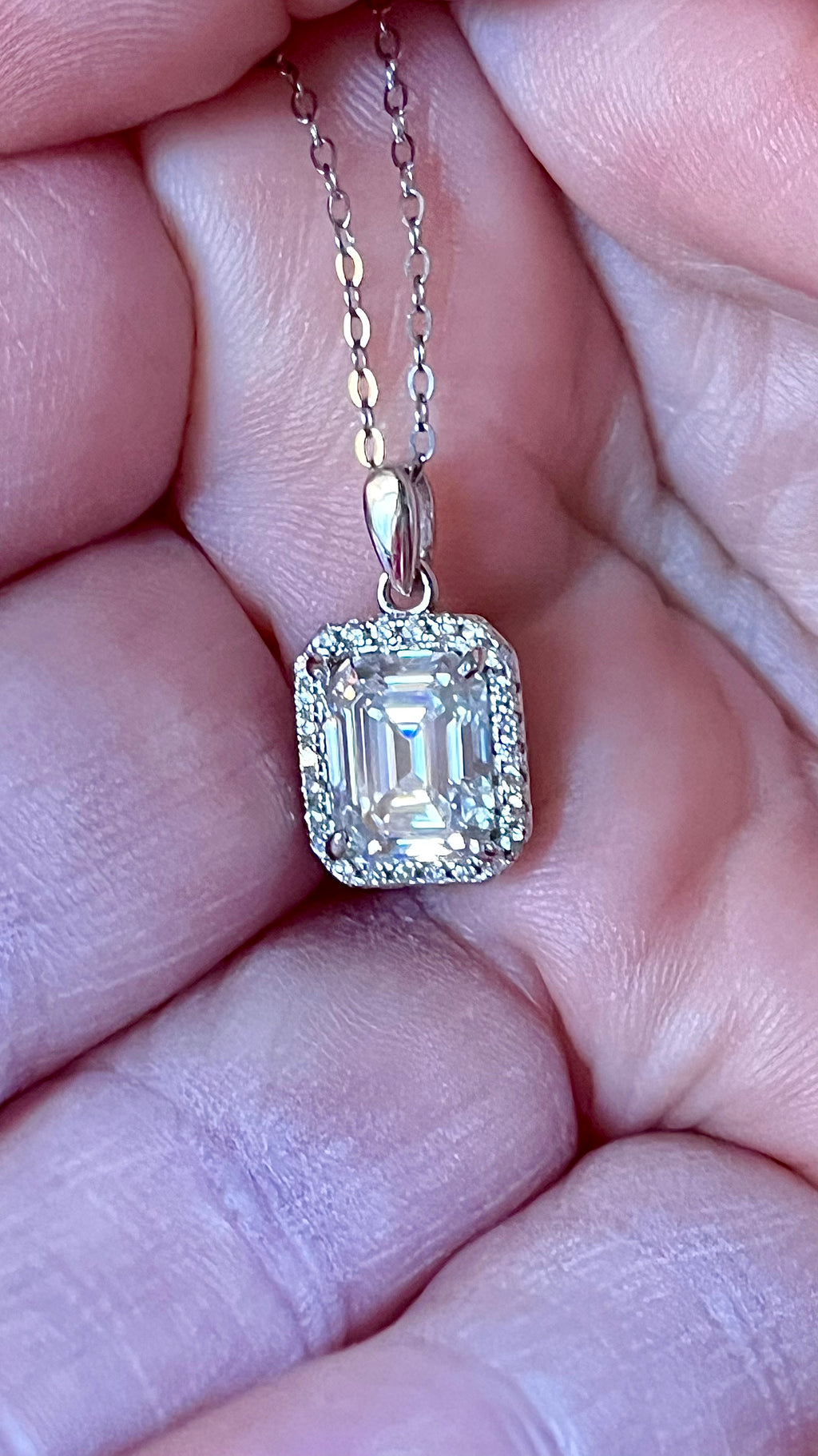 Moissanite necklace. An elegant 3ct certified emerald-cut Moissanite within a halo of shining white zircons, in 18k gold-embraced sterling!