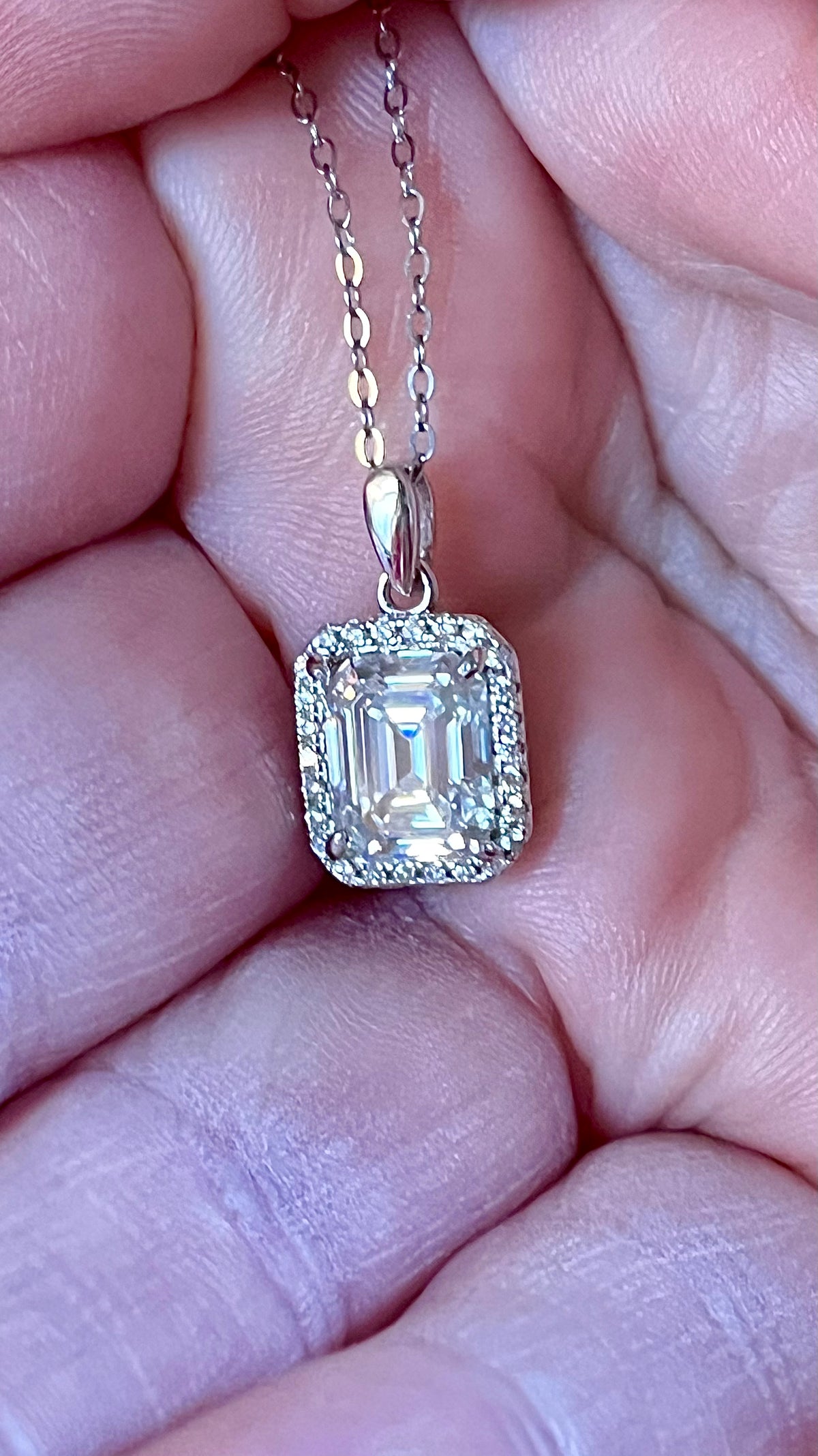 Moissanite necklace. An elegant 3ct certified emerald-cut Moissanite within a halo of shining white zircons, in 18k gold-embraced sterling!
