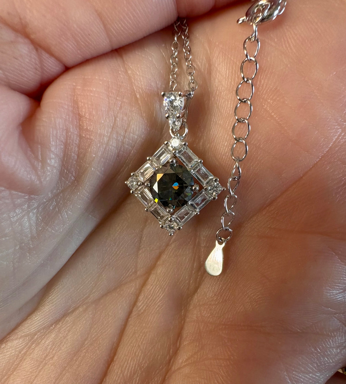 Moissanite necklace. A transfixingly gray 1ct certified round brilliant Moissanite centered in a halo of white zircons - a 2.25cttw pendant!
