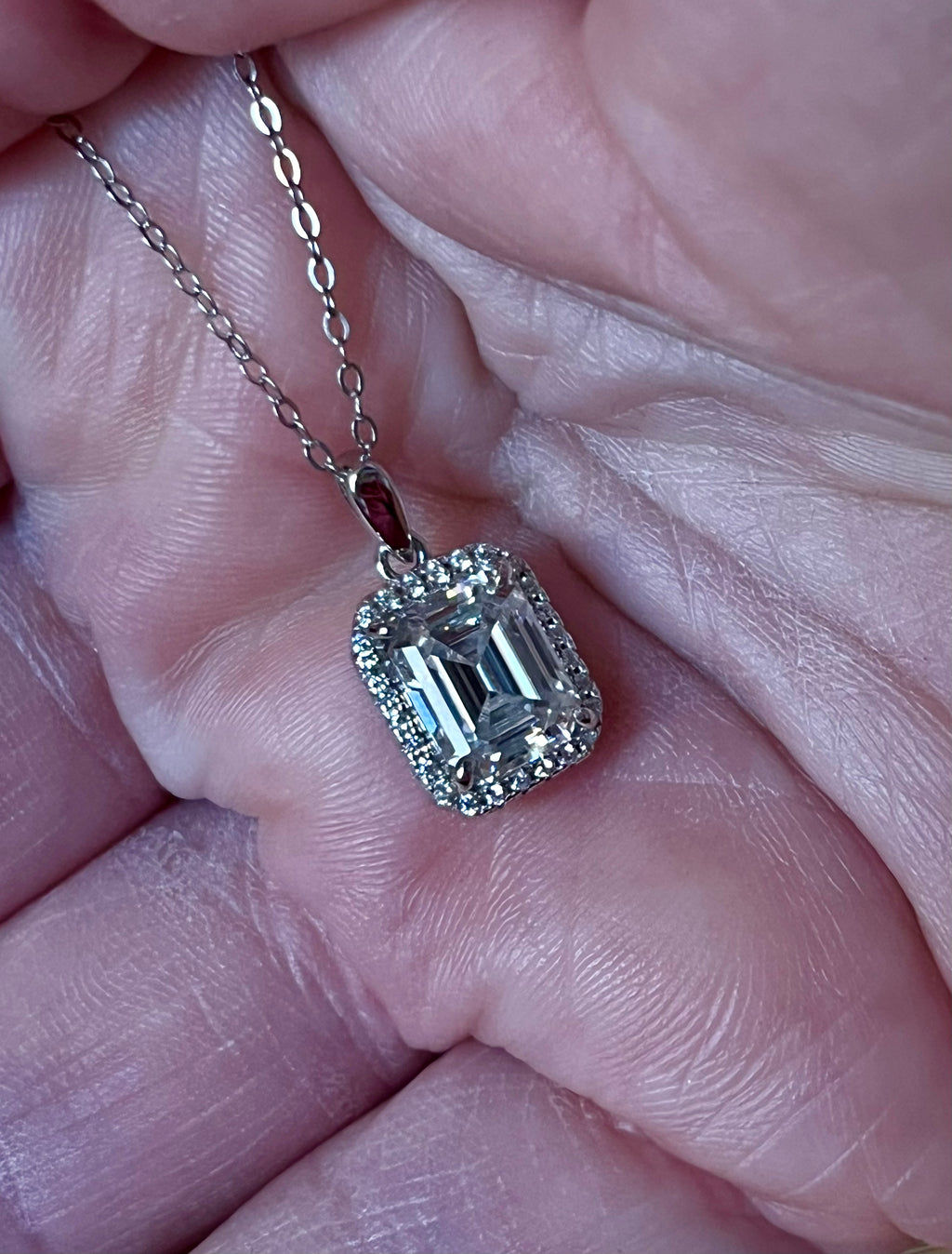 Moissanite necklace. An elegant 3ct certified emerald-cut Moissanite within a halo of shining white zircons, in 18k gold-embraced sterling!