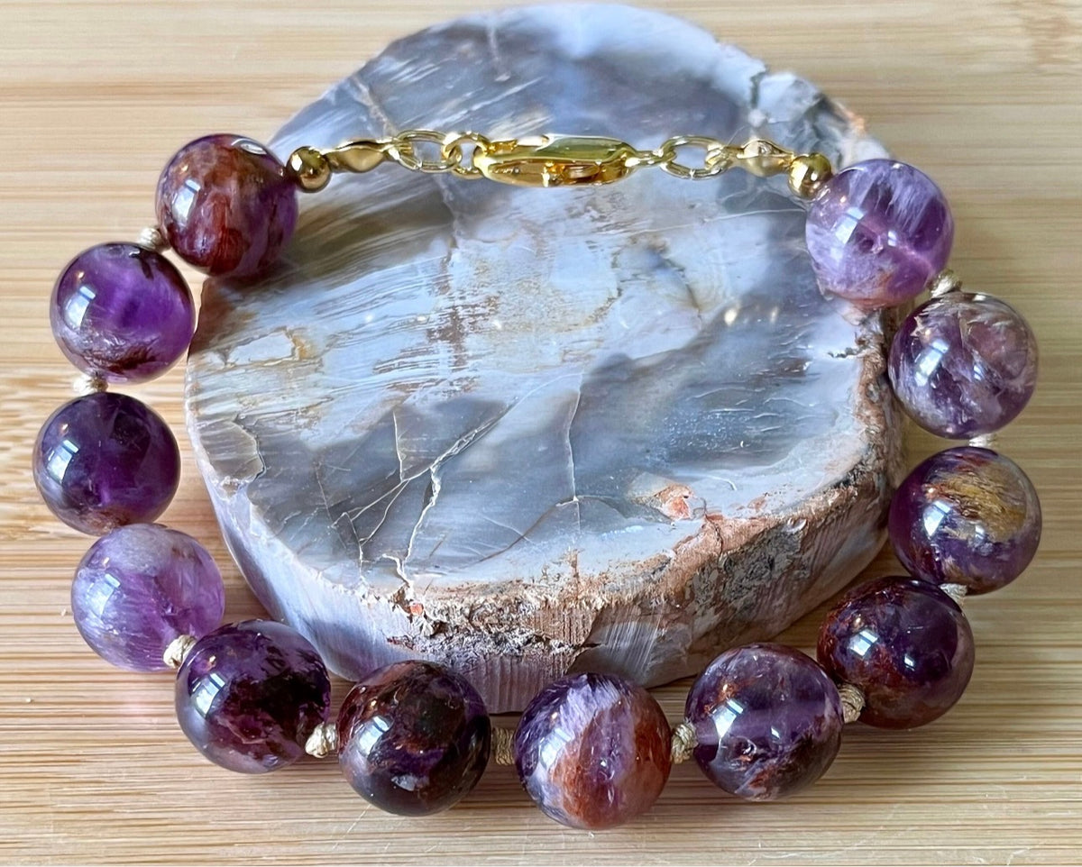 Super seven amethyst bracelet. AAA-grade 12mm “super seven”, mineral name cacoxenite amethyst, hand-knotted with silvery or golden hardware!
