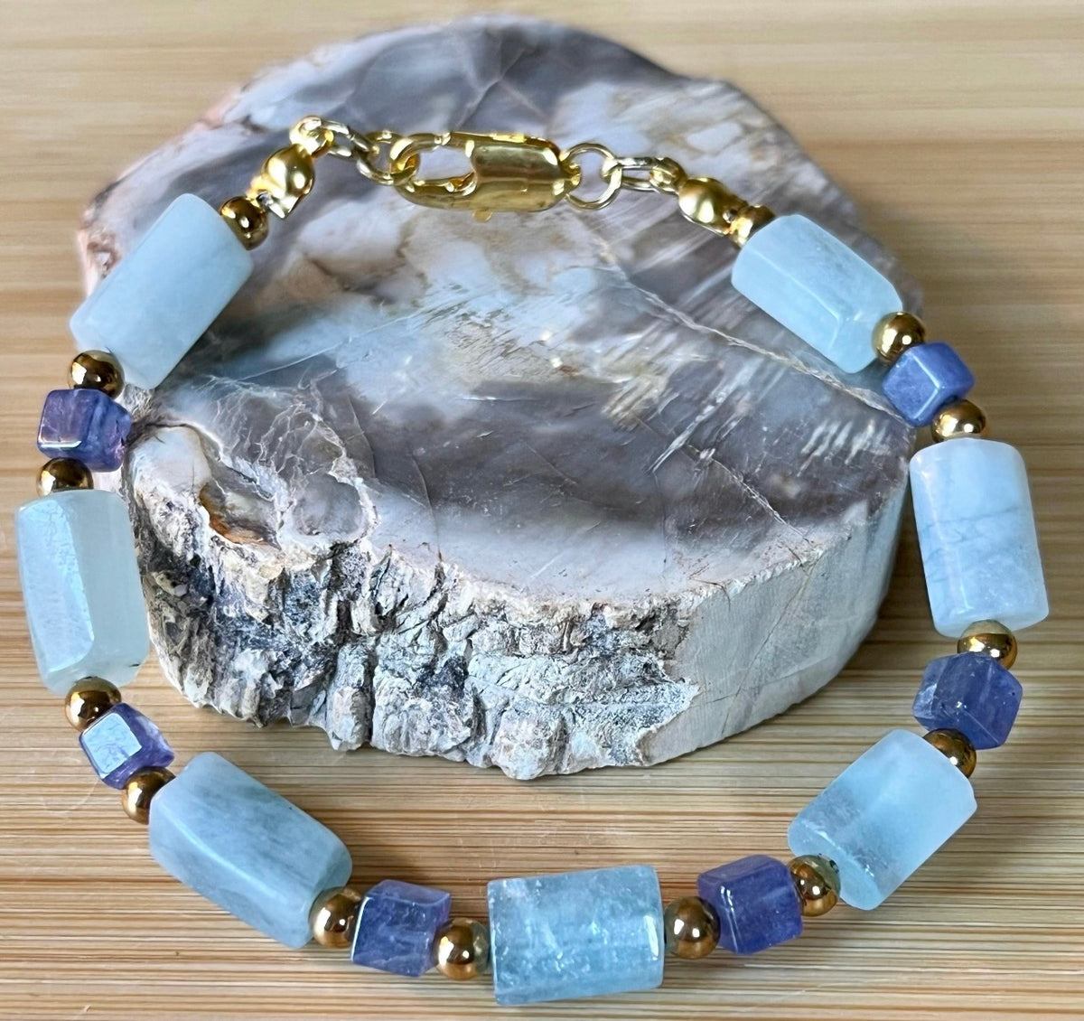 Aquamarine and tanzanite bracelet. The “True Blue” bracelet features trendy aquamarine barrels and dusky tanzanite cubes!