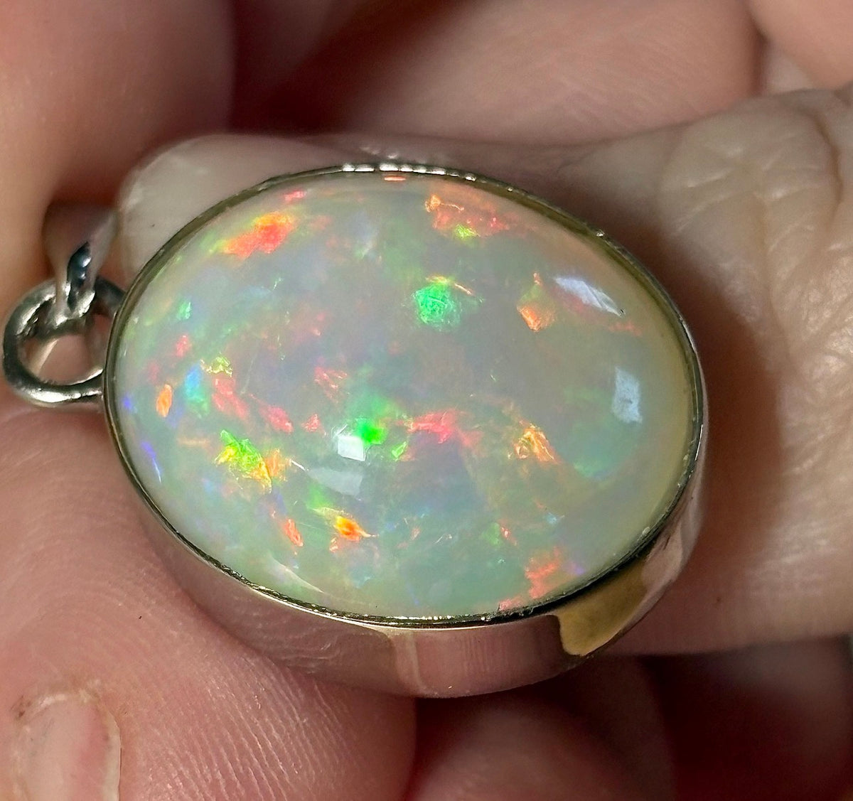 A 17.28ct AAA grade Ethiopian opal pendant with multi-patterned fire and beautiful play of color, hand-picked by Hand Knotted Jewelry!