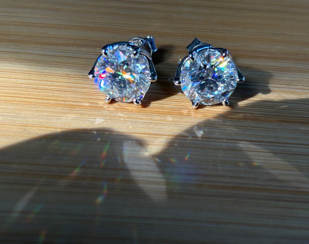 A 10ctw pair of double certified Moissanite studs in lotus-shaped sterling silver baskets!