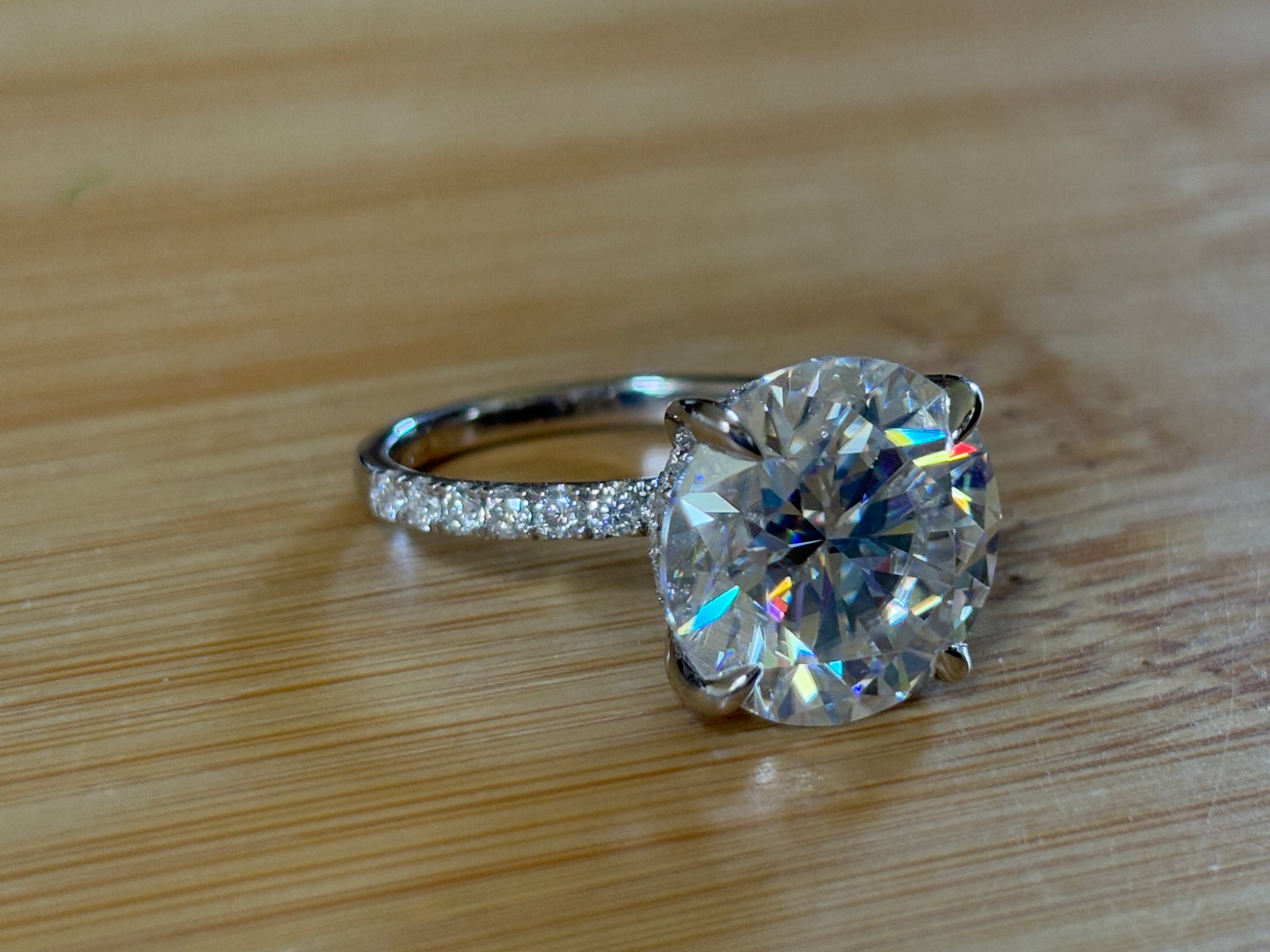Moissanite solitaire. A glorious 10ct 8H8A Moissanite in a 4-prong mounting with a Moissanite “hidden halo” and shoulders, an 11.3cttw ring!