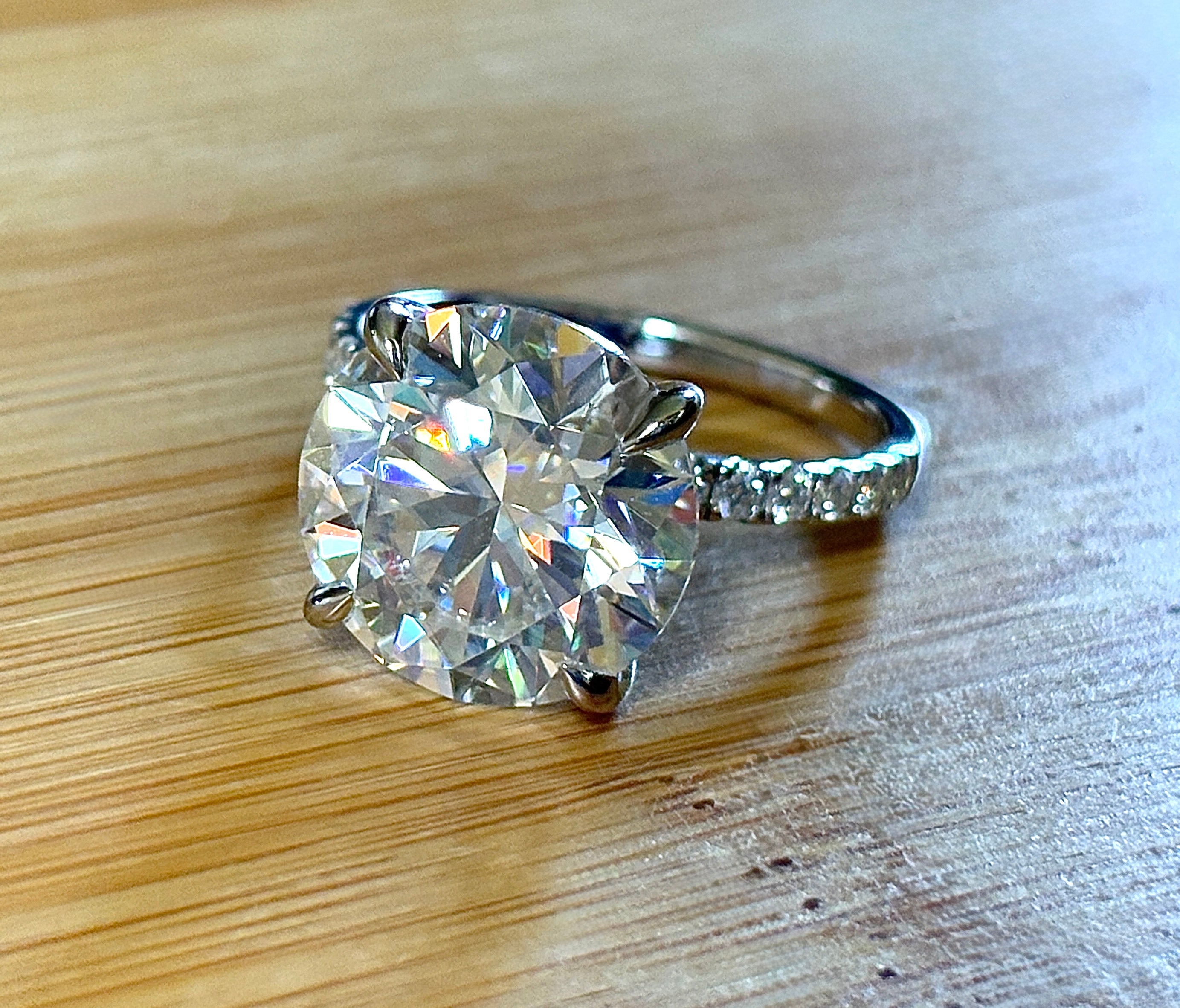 Moissanite solitaire. A glorious 10ct 8H8A Moissanite in a 4-prong mounting with a Moissanite “hidden halo” and shoulders, an 11.3cttw ring!