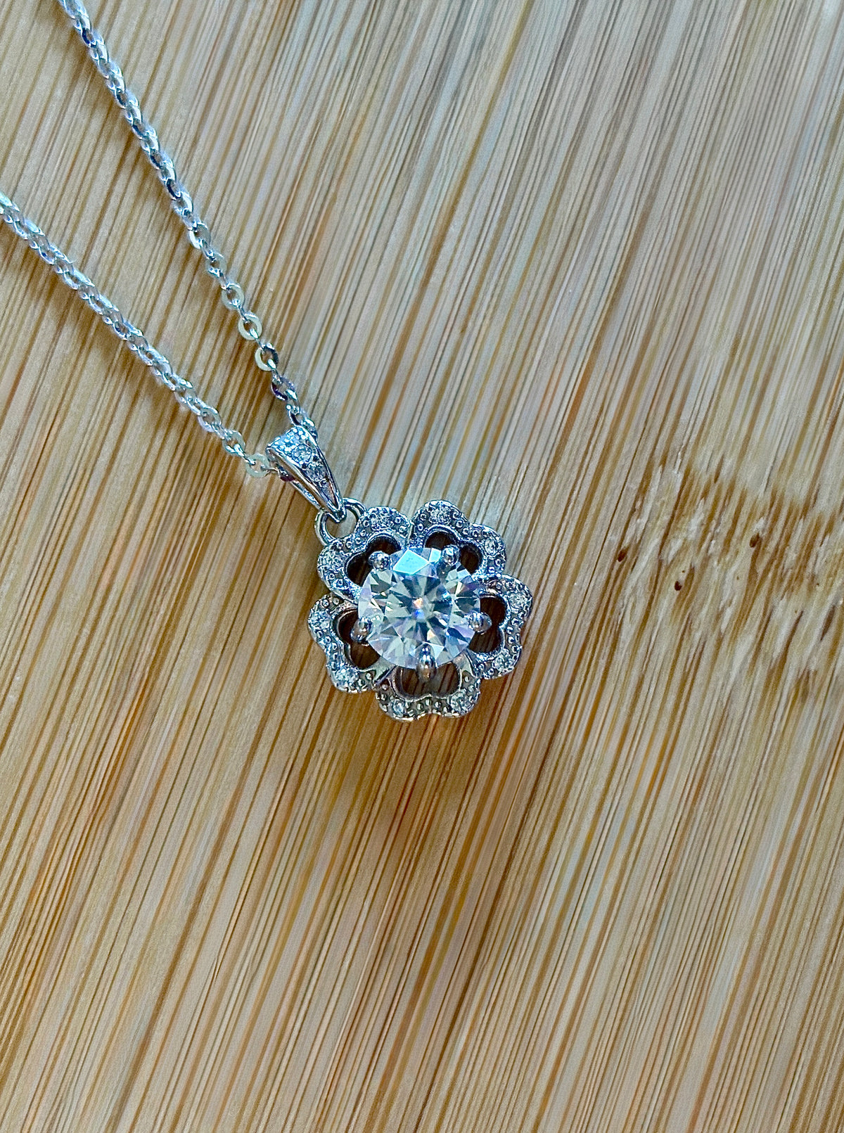 Moissanite necklace. A certified 1ct Moissanite hibiscus necklace with white zircon accents in solid sterling and white rhodium!