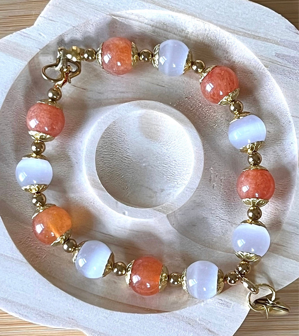 White selenite and tangerine chalcedony bracelet with raw brass and stainless steel components. The functioning brass locket is included!