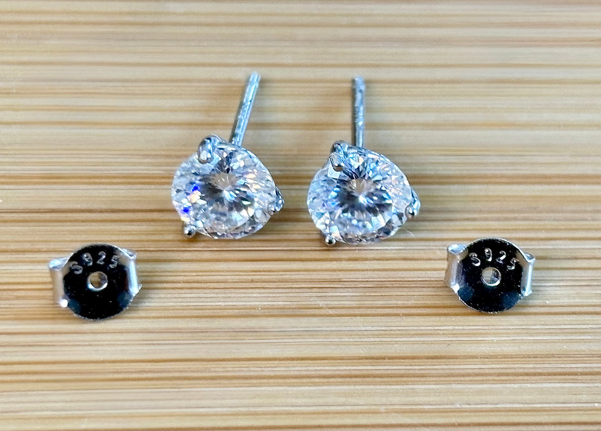 Moissanite studs. A 100-facet 2cttw pair of super bright, DOUBLE certified Moissanite studs in sterling silver and 18k white rhodium! Sublime!