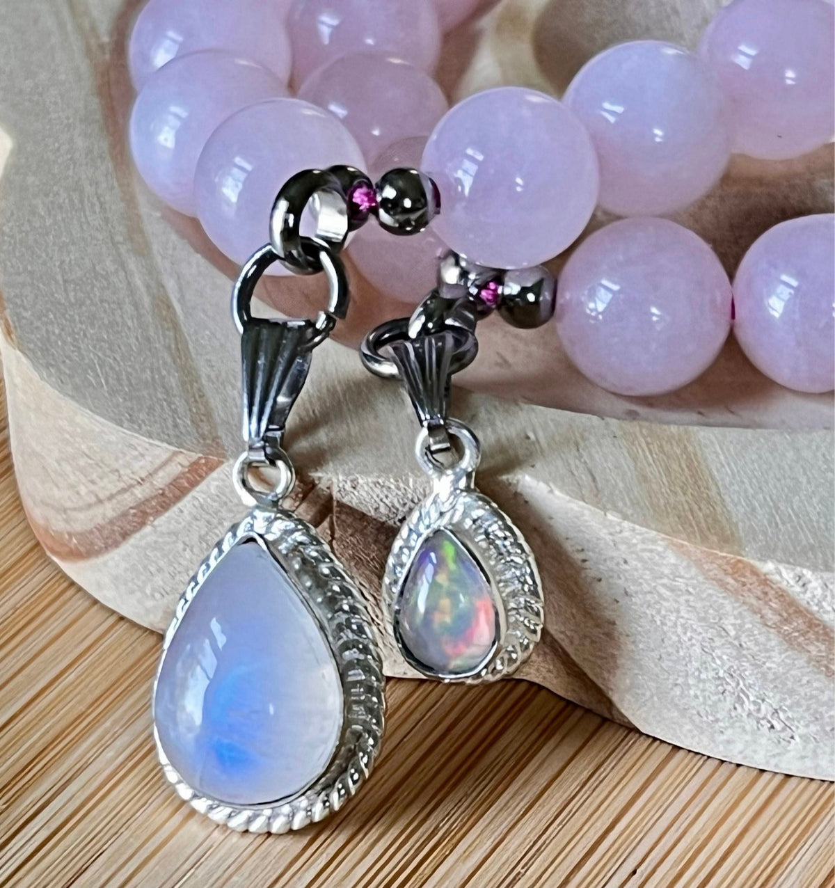 Madagascar rose quartz bracelet. 10mm beads with stainless steel components. The featured sterling silver pendants are sold separately.