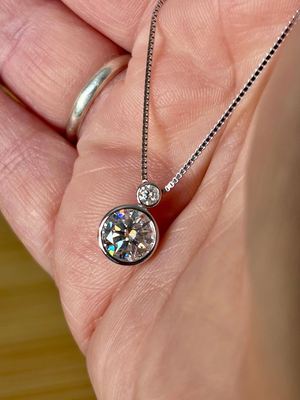 Moissanite necklace. A bright 2.1ctw certified Moissanite bezel pendant, with a 18” box chain and lobster claw clasp in sterling silver!
