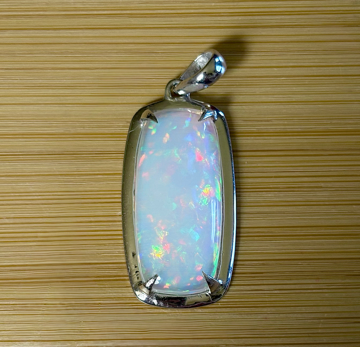 A 21ct AAA grade Ethiopian opal pendant, a handpicked opal and exclusive HKJ design! This lovely opal has gorgeous fire and play of color!