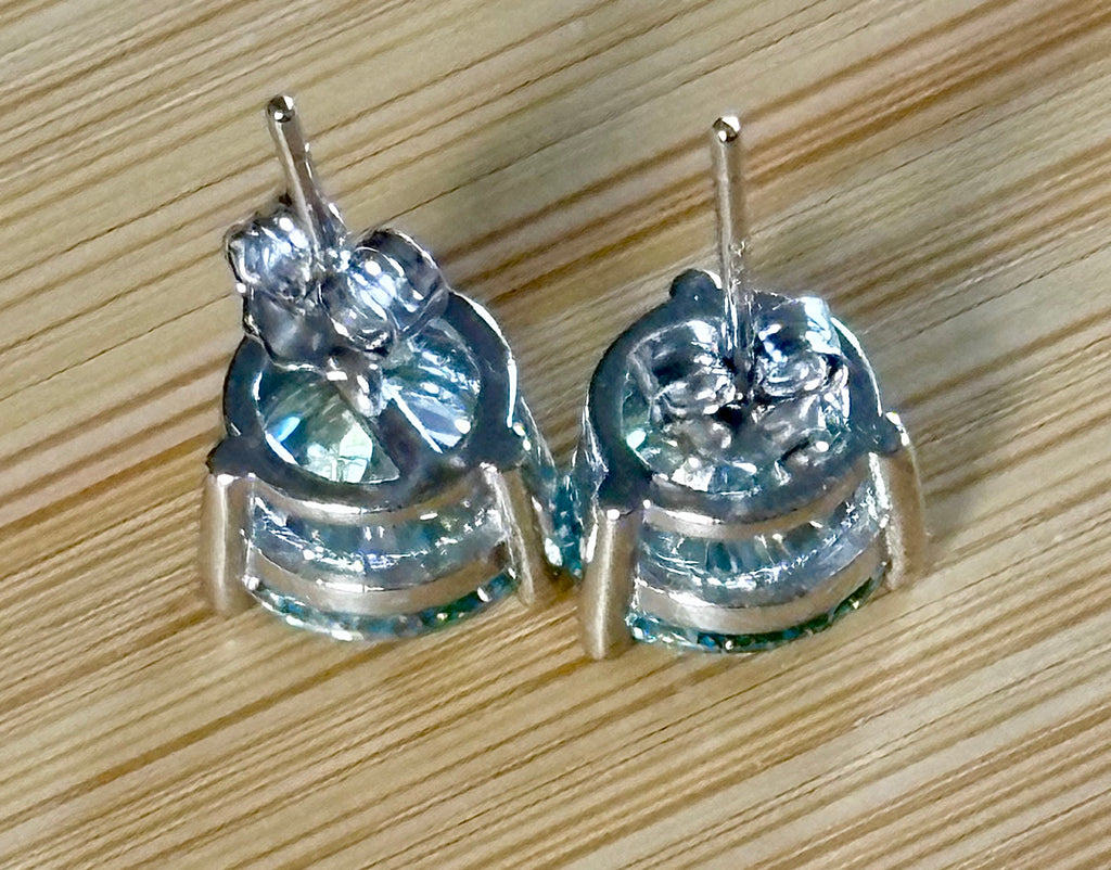 Moissanite earrings. A delicate certified 2cttw pair of 3-prong or 4-prong round brilliant Moissanites in 18k gold-embraced sterling silver baskets! Classic!