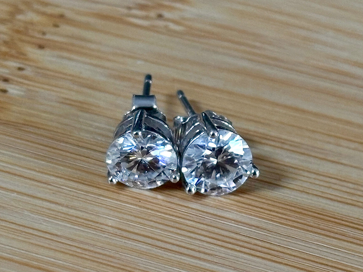 Moissanite earrings. A delicate certified 2cttw pair of 3-prong or 4-prong round brilliant Moissanites in 18k gold-embraced sterling silver baskets! Classic!
