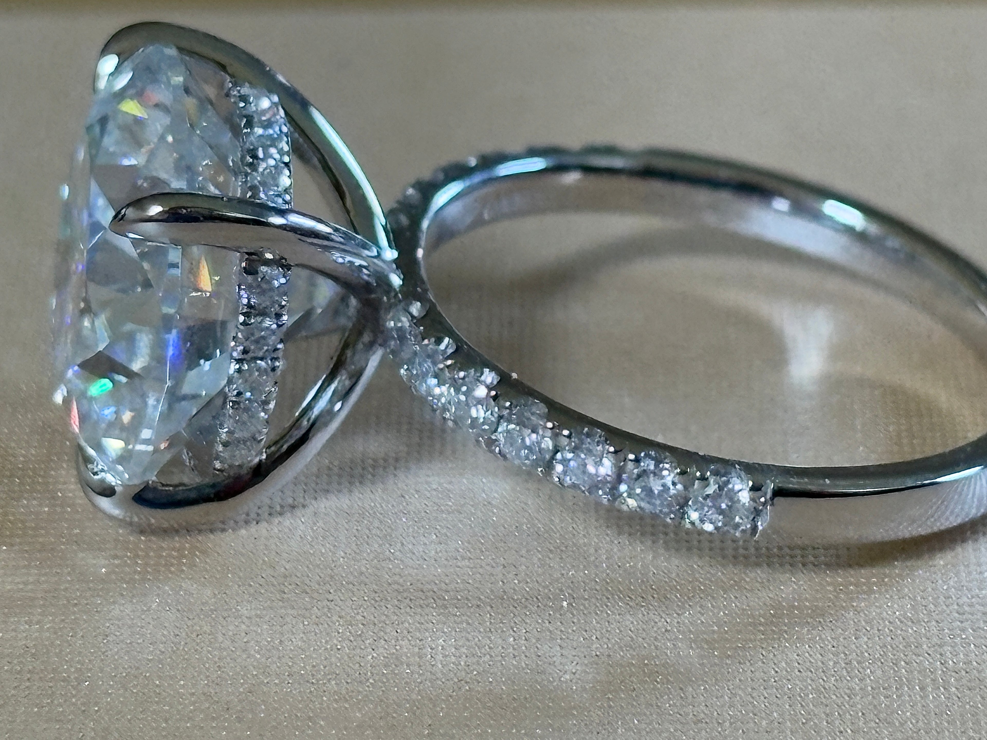 Moissanite solitaire. A glorious 10ct 8H8A Moissanite in a 4-prong mounting with a Moissanite “hidden halo” and shoulders, an 11.3cttw ring!