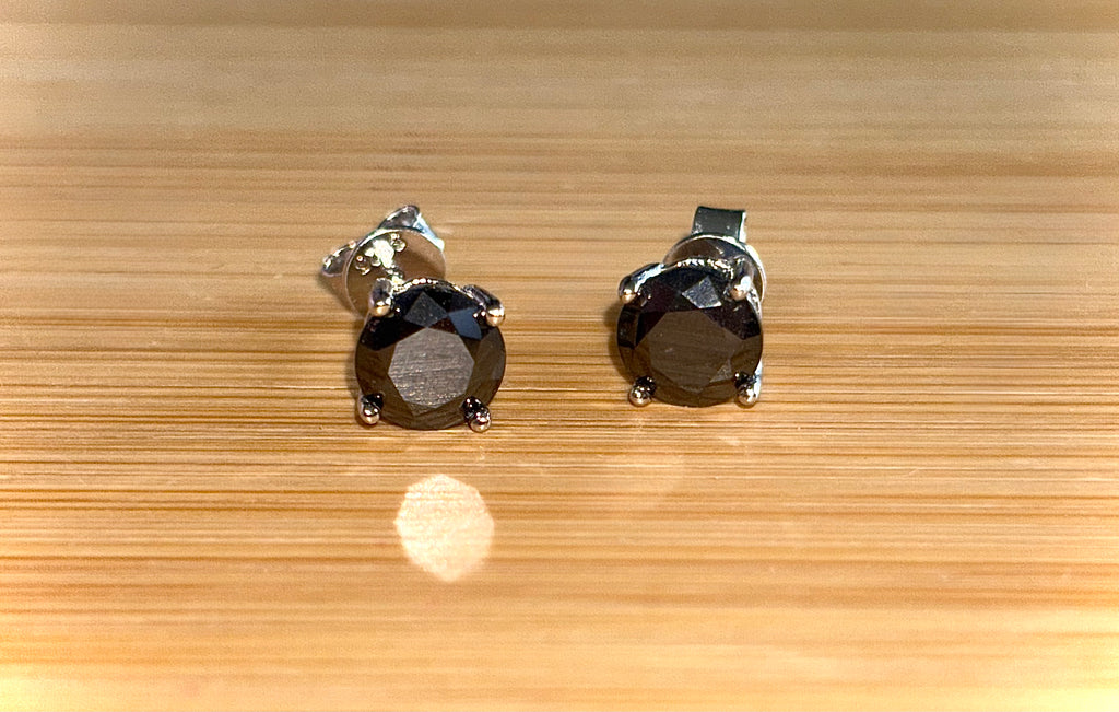 Moissanite studs. A 2cttw certified pair of black Moissanite studs in a sterling silver basket setting with 18k white gold plating!