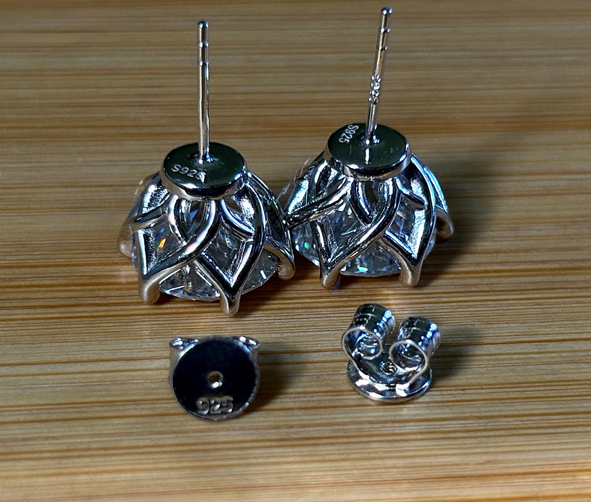 A 10ctw pair of double certified Moissanite studs in lotus-shaped sterling silver baskets!