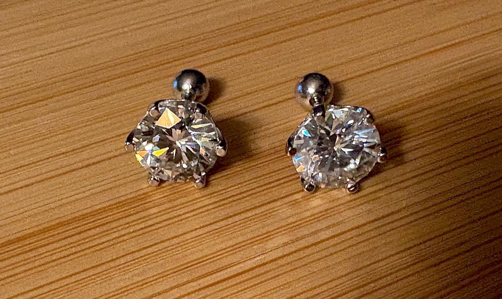 A certified pair of pretty, floral-inspired 2cttw or 4cttw Moissanite studs in poinsettia-shaped settings w/screwball backs OR 4cttw w/push backs!