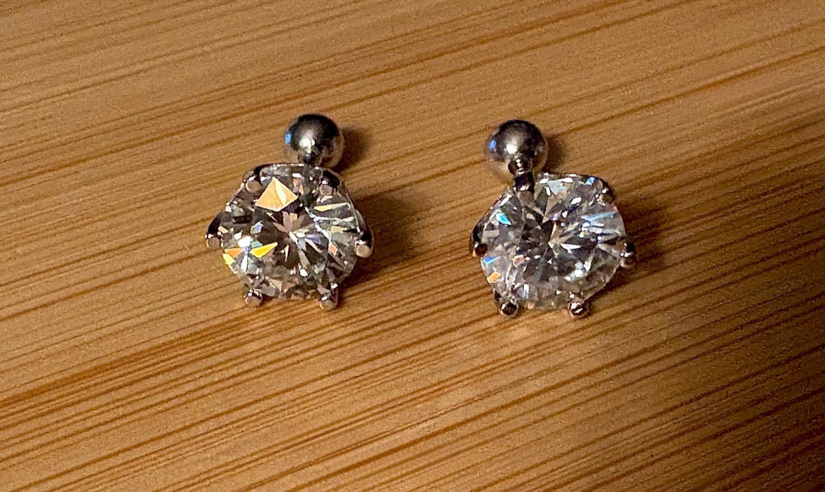 A certified pair of pretty, floral-inspired 2cttw or 4cttw Moissanite studs in poinsettia-shaped settings w/screwball backs OR 4cttw w/push backs!