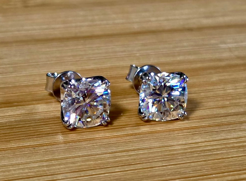 6ctw cushion-cut Moissanite studs in elegant sterling silver double-claw mountings! With brilliant faceting, these earrings are showstoppers!