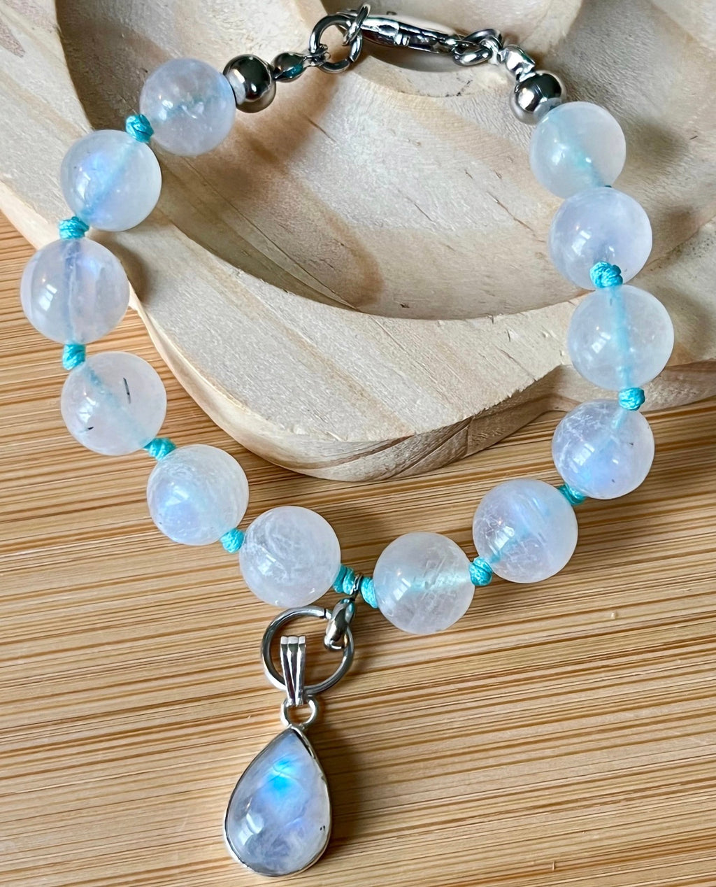 Rainbow moonstone bracelet, hand knotted with high quality 9-10mm beads! The solid sterling silver moonstone pendant is *optional*.