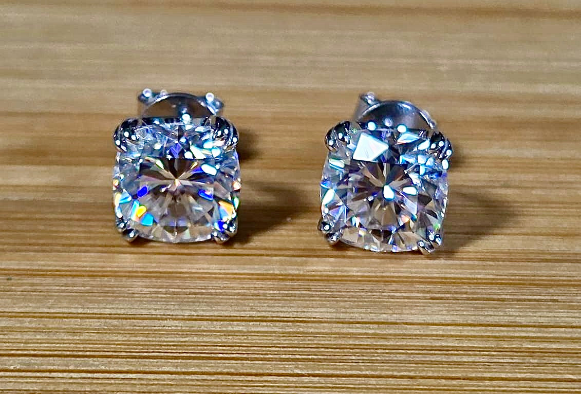 6ctw cushion-cut Moissanite studs in elegant sterling silver double-claw mountings! With brilliant faceting, these earrings are showstoppers!