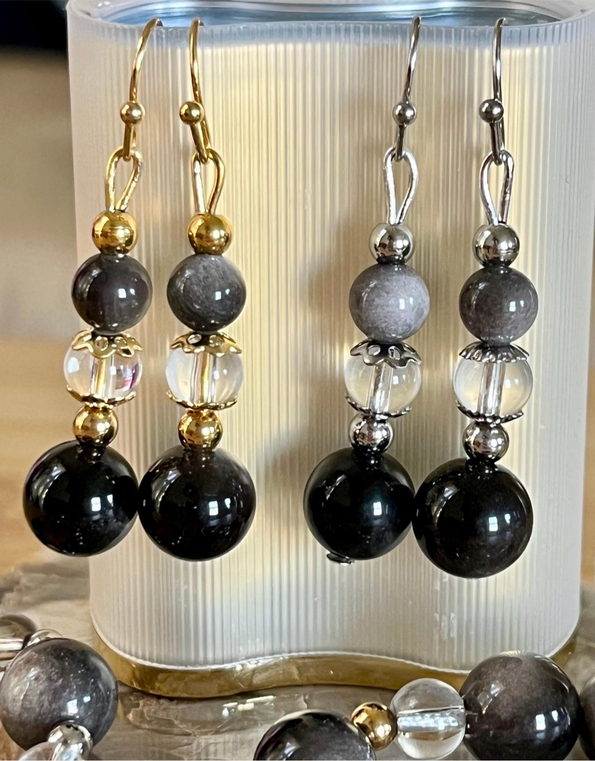 Silver sheen obsidian and clear quartz bracelet and earrings. Pair the “Silver Bells” bracelet and/or earrings with your little black party dress and be the Belle of the Ball!
