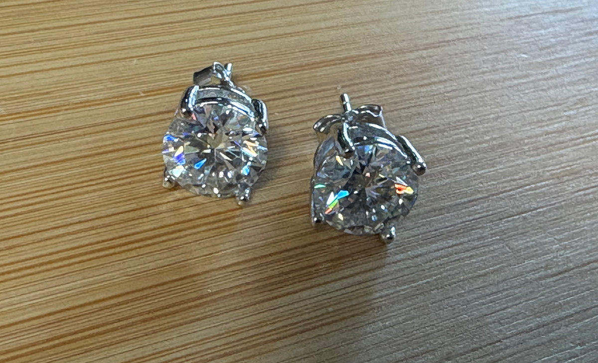 Moissanite earrings. A delicate certified 2cttw pair of 3-prong or 4-prong round brilliant Moissanites in 18k gold-embraced sterling silver baskets! Classic!