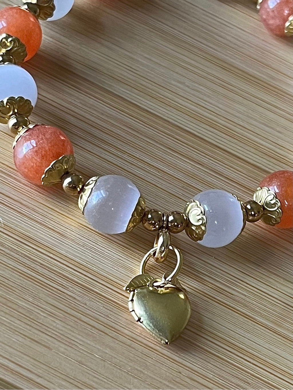 White selenite and tangerine chalcedony bracelet with raw brass and stainless steel components. The functioning brass locket is included!