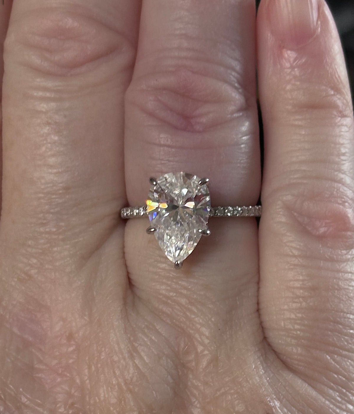 A certified 5ct pear-cut Moissanite solitaire in 925 sterling OR 935 Argentium silver with 18k, with pavé-set Moissanite shoulders and Moissanite hidden halo!