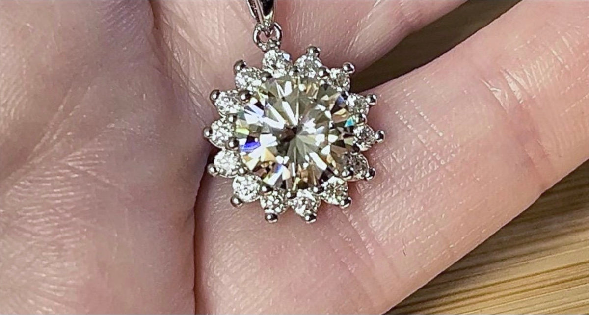 Moissanite necklace. A 1ct or 3ct Moissanite in a halo of sparkling white zircons (I call it the “Sunflower” pendant)! In sterling silver and 18k!