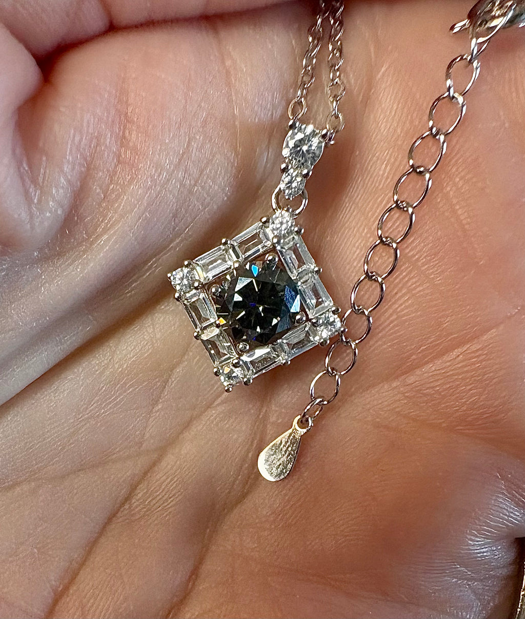 Moissanite necklace. A transfixingly gray 1ct certified round brilliant Moissanite centered in a halo of white zircons - a 2.25cttw pendant!