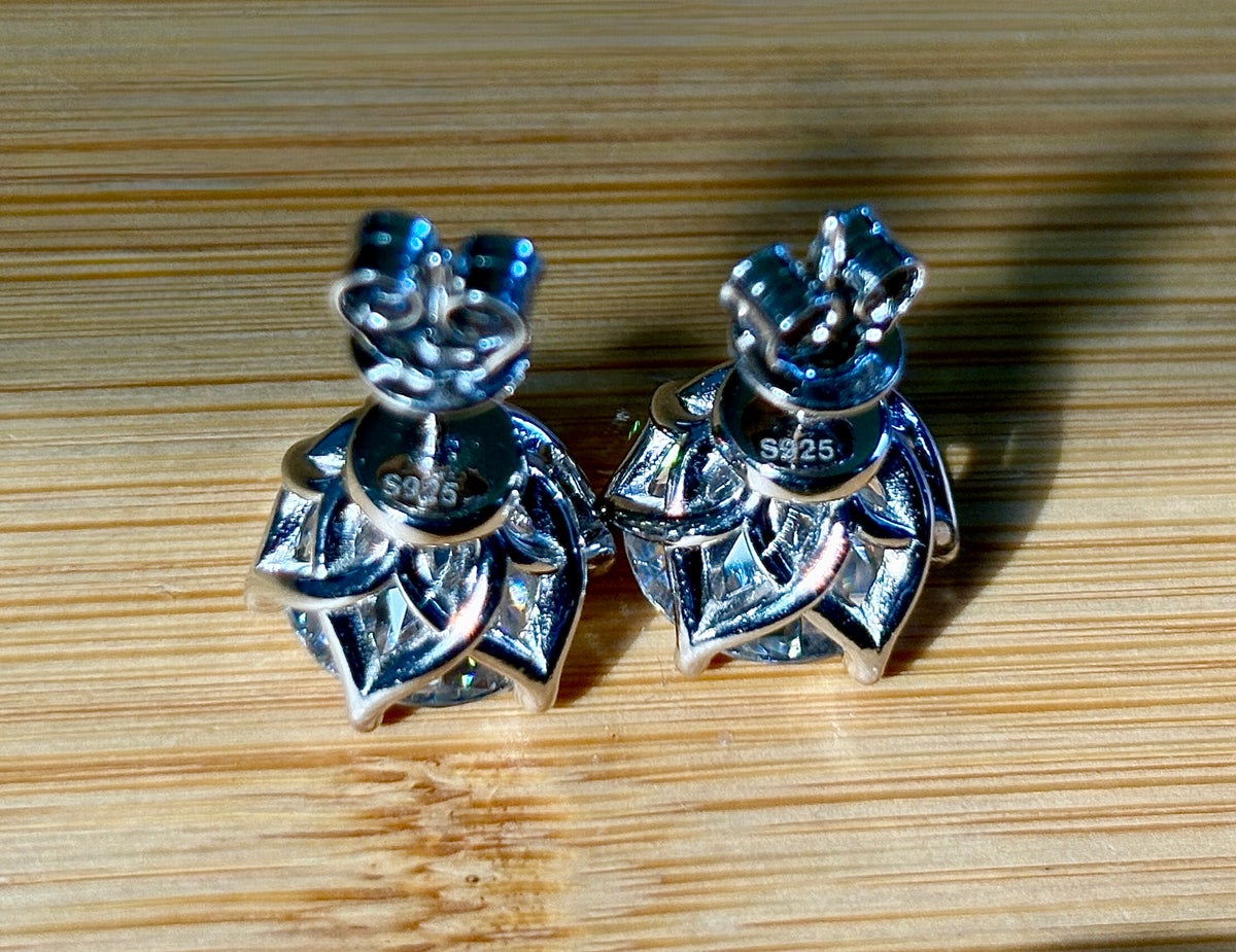 A 10ctw pair of double certified Moissanite studs in lotus-shaped sterling silver baskets!