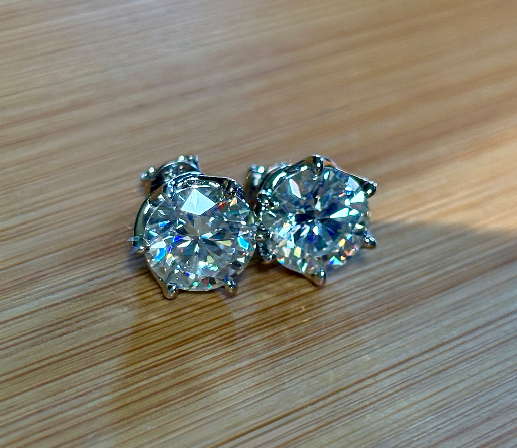 A 10ctw pair of double certified Moissanite studs in lotus-shaped sterling silver baskets!
