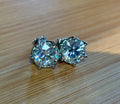A 10ctw pair of double certified Moissanite studs in lotus-shaped sterling silver baskets!