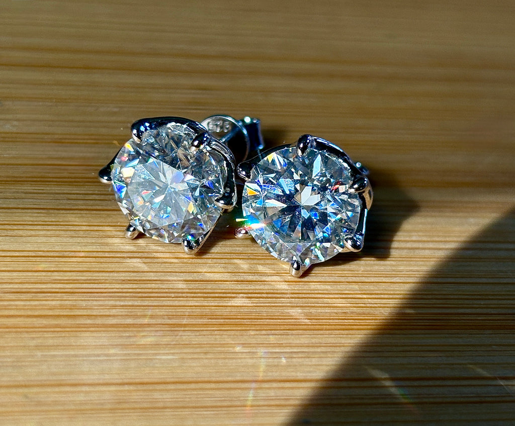 A 10ctw pair of double certified Moissanite studs in lotus-shaped sterling silver baskets!