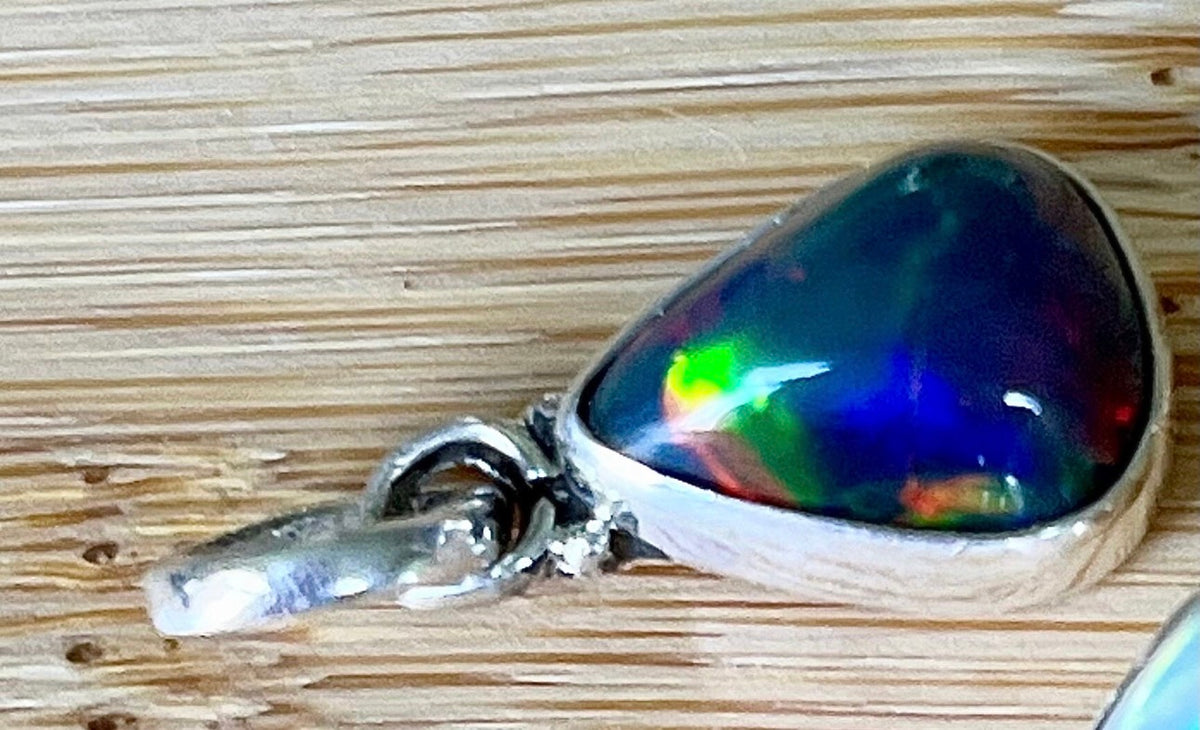2.99ct Ethiopian opal pendant. AAA grade smoked opal cabochon pear in solid sterling silver. This flashy stone measures 9.6mm x 13mm!