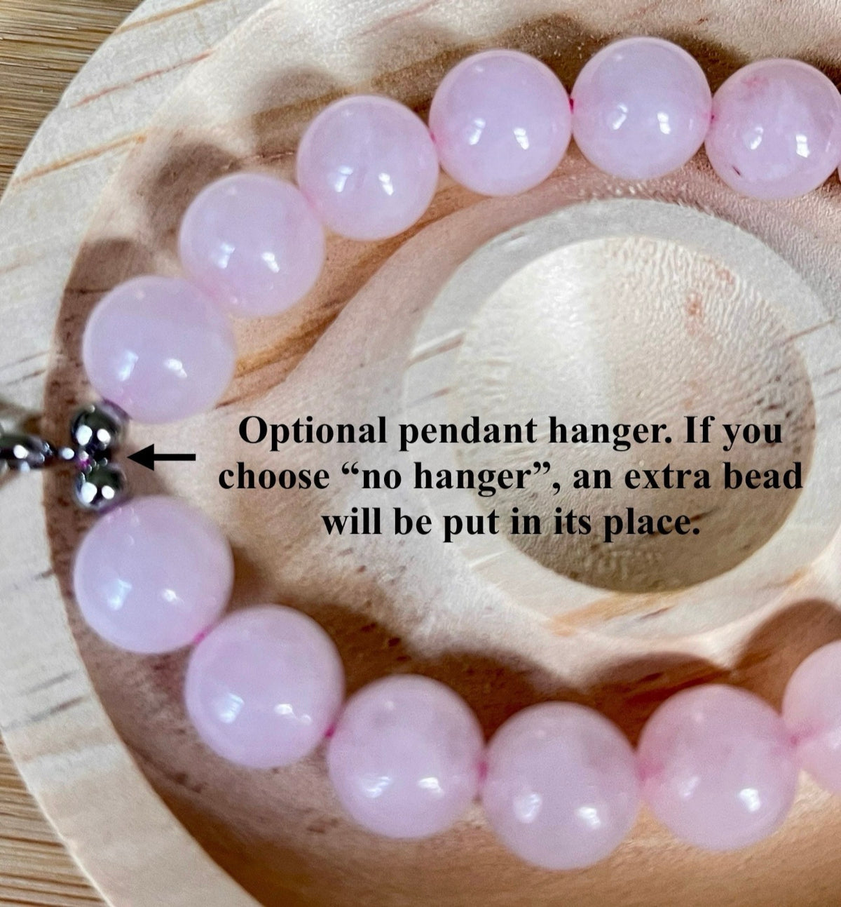 Madagascar rose quartz bracelet. 10mm beads with stainless steel components. The featured sterling silver pendants are sold separately.