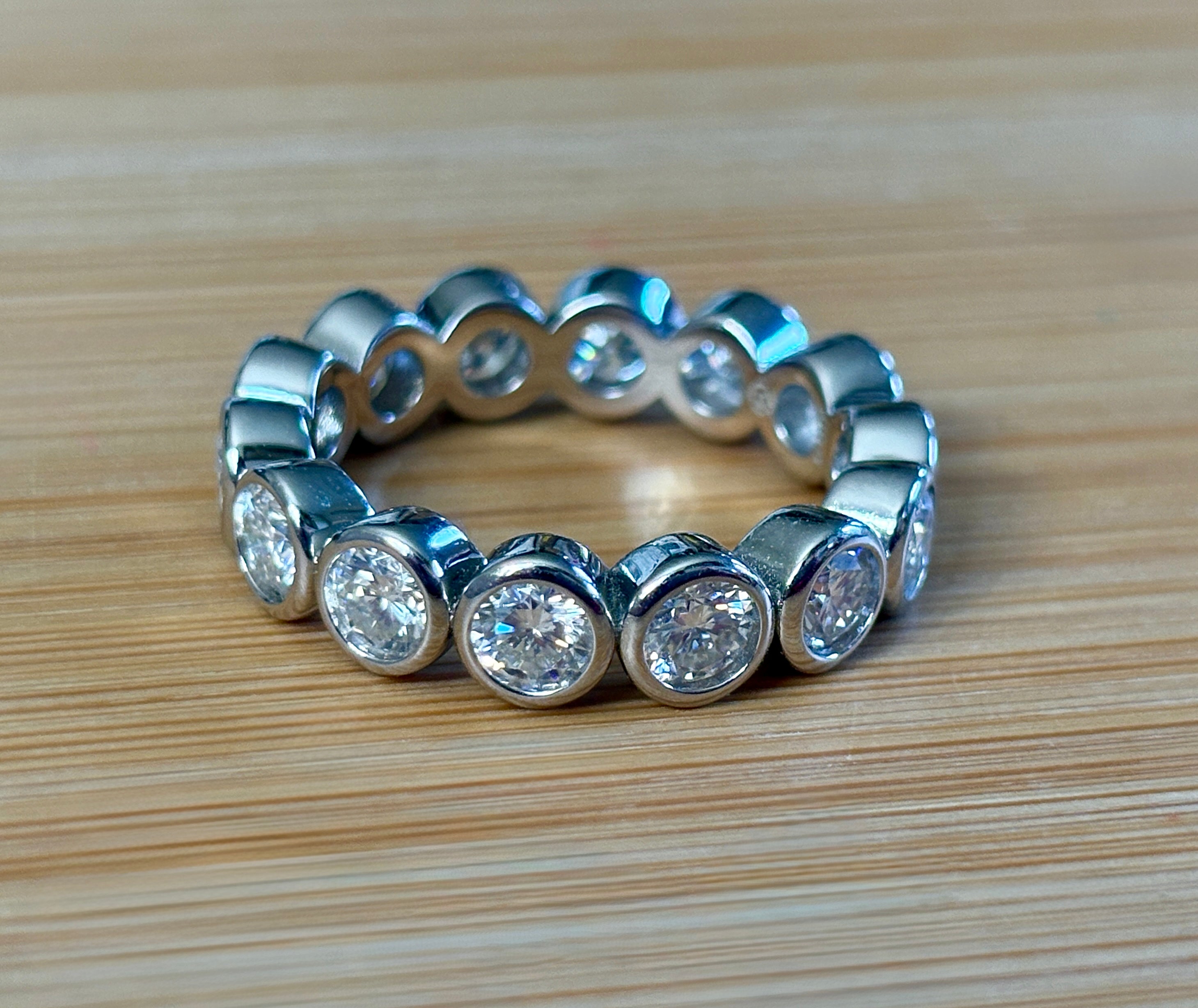 Moissanite ring. A certified, bezel-set eternity ring with 1/2ct round brilliant Moissanites set in a heavy, solid Argentium silver band!